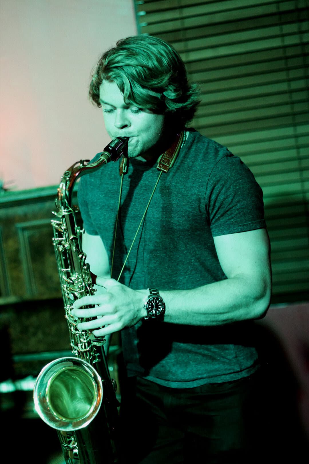 Jayden playing with a sextet at a well-lit venue